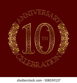 10th anniversary celebration vintage patterned logo symbol. Golden circular ornate emblem on red.