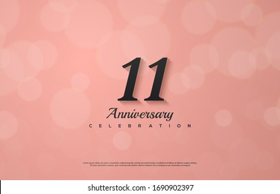 11th anniversary background with an illustration of a black colored number on a pink background.