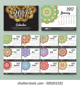 12 month desk calendar template for print design with colored Mandala background. 2017 calendar design start with Sunday. 7x5 inches size with bleeds vector illustration