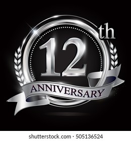 12th silver anniversary logo with ring and ribbon. silver anniversary laurel wreath design.