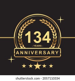 134 years anniversary golden color with circle ring and stars isolated on black background for anniversary celebration event luxury gold premium vector