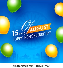 15th of August, Happy Independence Day Text on Blue Ashoka Wheel Background Decorated Saffron and Green Glossy Balloons.