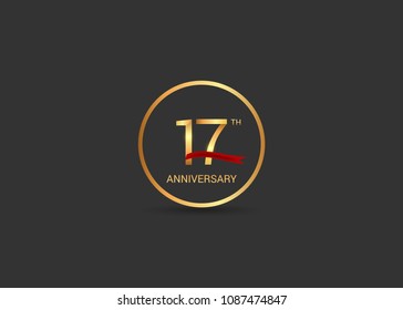17 anniversary vector design golden color with ring and red ribbon isolated on black background