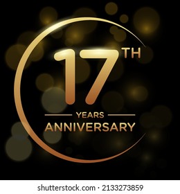 17 years anniversary celebration. Anniversary logo with ring and elegance golden color isolated on black background, vector design for celebration, invitation card, greeting card, and banner