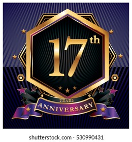 17 years golden anniversary logo celebration with ring and ribbon.