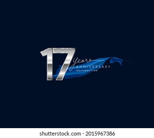 17th Years Anniversary celebration logotype silver colored with blue ribbon and isolated on dark blue background