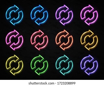 2 arrow circle icon set. 3d color neon signs on black brick background. Glowing refresh reload rotation loop symbol. Electric lamp technology outline. Double arrows circle. Bright vector illustration.