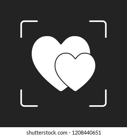 2 hearts. Simple icon. White object in camera autofocus on dark background