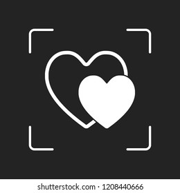 2 hearts. Simple icon. White object in camera autofocus on dark background