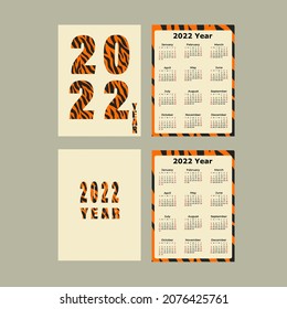 2 tiger prints on calenadr. calendar with the symbol of 2022. year of the tiger on print.	