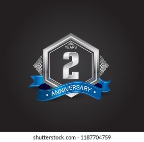 2 years anniversary logotype design with blue ribbon, silver hexagon, and ornament isolated on dark background. Vector template for celebration company event, greeting card, and invitation card