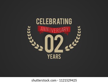 2 Years Anniversary logotype with golden colored font numbers, with ribbon and laurel, isolated on black background for company celebration event, birthday