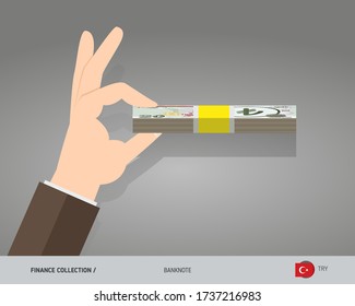 20 Turkish Lira banknotes. A bundle of money in hand. Flat style vector illustration.
