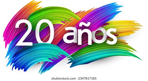 20 years at spanish paper word sign with colorful spectrum paint brush strokes over white. Vector illustration.