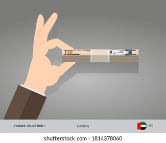 Billetes Dirham de los Emiratos Árabes Unidos. Un paquete de dinero en mano. Ilustración vectorial de estilo plano.