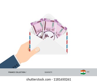 2000 Indian Rupee Banknotes in envelope hold in hand. Flat style opened white envelope with cash. Salary payout or corruption concept.