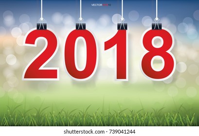 2018 Happy New Year background with grass field and light blurred bokeh background. Vector illustration.