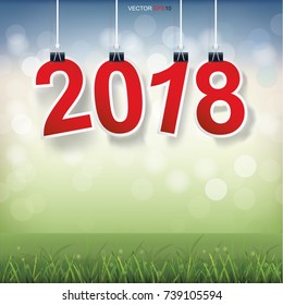 2018 Happy New Year background with grass field and light blurred bokeh background. Vector illustration.