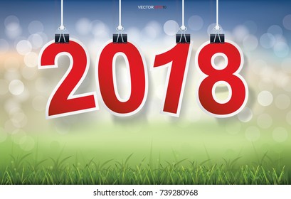 2018 Happy New Year background with grass field and light blurred bokeh background. Vector illustration.