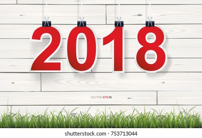 2018 Happy new year background with white vintage wooden texture background and green grass field. Vector illustration.