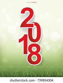 2018 Happy New Year with grass field and light blurred bokeh background. Vector illustration.