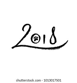 2018 year of the dog. Number of the new year for chinese lunar calendar, decorated with dag paw print. Brush lettering by black ink on white paper.