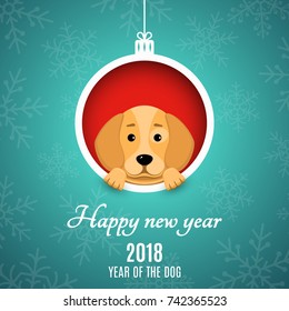 2018 year of the dog. Paper clippings. Advertising banner. Christmas ball of paper. A cartoon dog peeks out of the hole. White text. Snowflakes on a blue background. Vector illustration