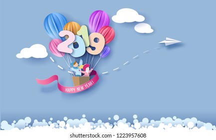 2019 New Year design card with kids with air balloons on blue sky background. Vector paper art illustration. Paper cut and craft style.