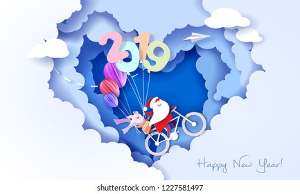 2019 New Year design card with Santa Claus and funny pig on bicycle on blue sky background with heart shaped clouds. Vector paper art illustration. Paper cut and craft style.
