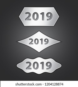 2019 text on metallic shiny banners. Differnt shapes of buttons on dark background. Plates with numbers. Gray tablets. Web elements. Vector illustration