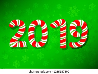 2019 year numbers. Christmas candy on a green snow-covered background.