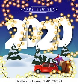2020, happy New Year, white volumetric numbers wrapped with garland , winter landscape on background and red vintage car carrying Christmas tree