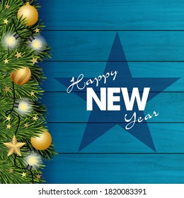 2021- card for the New Year with fir branches decorated with Christmas balls and light garlands on a blue plank background.