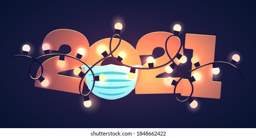 2021 lettering with surgical mask under garland lights over dark background