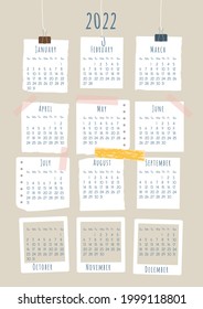 2022 calendar. Each month is framed in the form of a piece of paper with text or a photo frame. Week starts on Sunday. Vector illustration, vertical A4 format.