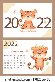 2022 calendar. Set September and cover. Cute tiger in a wreath of autumn leaves and a cup in a paw. horizontal A4 template. Week starts on Monday. Year of the Tiger in Chinese or oriental