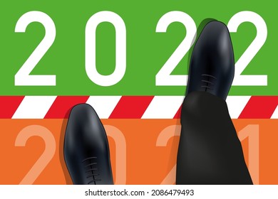 2022 greeting card showing a man’s feet viewed from above crossing a line symbolizing the transition to the new year.
