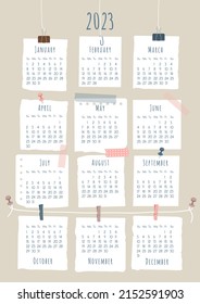 2023 calendar template. Each month is framed in the form of a piece of paper pinned or taped to wall. Week starts on Sunday. Vector illustration, vertical A4 format.