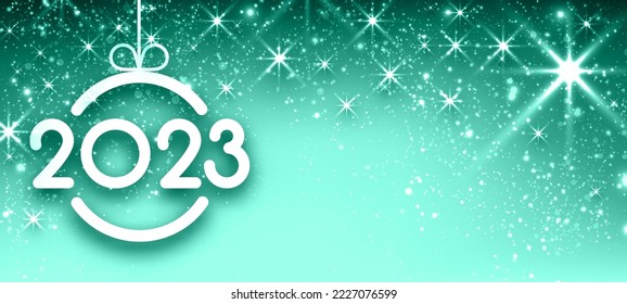 2023 sign in christmas bauble on green background with sparkling stars. Space for text.
