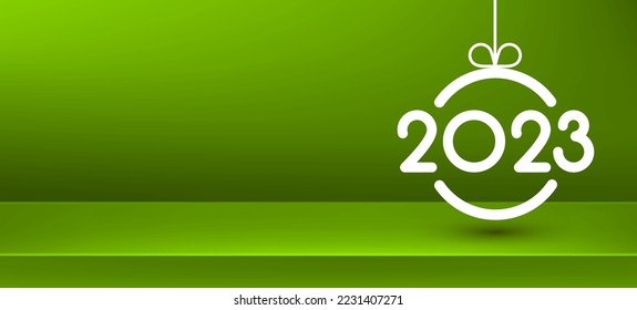 2023 sign in christmas bauble on green background with empty podium. Space for text.