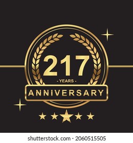 217 years anniversary golden color with circle ring and stars isolated on black background for anniversary celebration event luxury gold premium vector