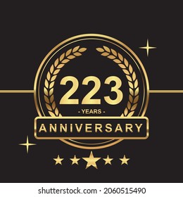 223 years anniversary golden color with circle ring and stars isolated on black background for anniversary celebration event luxury gold premium vector