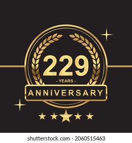 229 years anniversary golden color with circle ring and stars isolated on black background for anniversary celebration event luxury gold premium vector