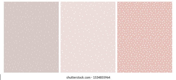 3 Cute Abstract Geometric Vector Patterns. White, Pink and Beige Color Design. Brushed Raindrops on a Light Brown Backgound. Irregular White Dots on a Light Pink.Romantic Print With White Tiny Hearts.