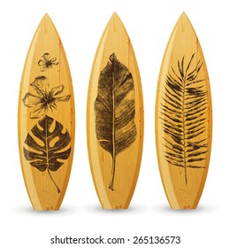 3 wooden surfboards with hand drawn tropical leaves