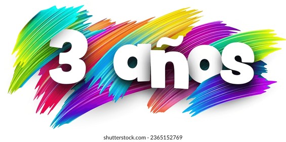 3 years at spanish paper word sign with colorful spectrum paint brush strokes over white. Vector illustration.