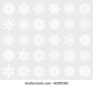 30 white snowflakes on gray background (isolated).