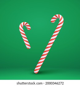 3d Christmas candy canes. Xmas classic dessert element isolated on green background.