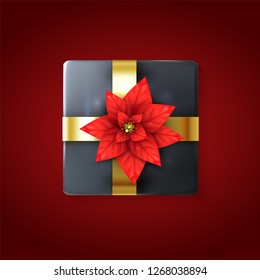 3D Gift box decorated with Realistic Poinsettia flower and gold ribbon. Xmas backdrop design template. Top view. Black holidays tied gift box isolated on red background. Vector illustration