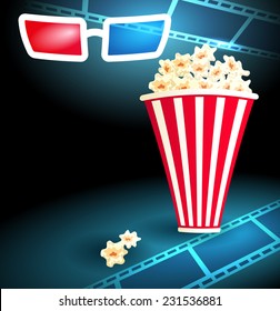 3d glasses in dark movie theater with popcorn and film strip